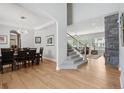 Open-concept floor plan with hardwood floors, leading to a dining area and a cozy living space at 6553 S Sedalia St, Aurora, CO 80016
