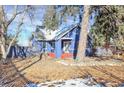 Charming blue home with red-painted porch steps and mature trees at 5725 W Mississippi Ave, Lakewood, CO 80226