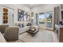 Inviting living area with a large window, a cozy sofa, and stylish decor for relaxation and entertainment at 487 Interlocken Blvd # 104, Broomfield, CO 80021