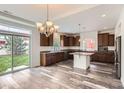 Beautiful kitchen with dark wood cabinets, granite countertops, stainless appliances and eat in dining area at 133 Poppy View Ln, Erie, CO 80516