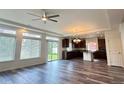 Beautiful living room with lots of natural light, hardwood floors, and connected modern kitchen at 133 Poppy View Ln, Erie, CO 80516