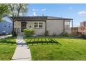 Inviting home exterior with a stylish pergola, lush lawn, and an attractive walkway at 785 Dexter St, Denver, CO 80220