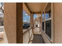 View of a cozy covered front porch featuring a white railing and earth-toned column at 3607 Dinosaur St, Castle Rock, CO 80109
