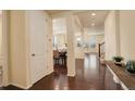 Inviting entryway with hardwood floors leading to open-concept living and dining areas with lots of natural light at 13351 Olive Way, Thornton, CO 80602