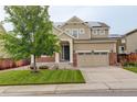 Charming two-story home with stone accents, solar panels, well-maintained lawn, and an attached two-car garage at 13351 Olive Way, Thornton, CO 80602