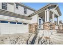 House exterior showcasing stone accents and a porch at 5583 S Elk Ct, Aurora, CO 80016