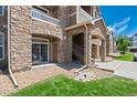 Stone condominium building exterior showcasing architectural details and covered stairwell at 7440 S Blackhawk St # 104, Englewood, CO 80112