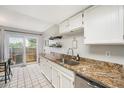 Well-lit kitchen features granite countertops, stainless steel appliances, and a sliding door to the outdoors at 8873 Yukon St, Broomfield, CO 80021