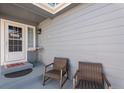 Cozy covered front porch with seating area provides a warm welcome at 10144 Madison St, Thornton, CO 80229