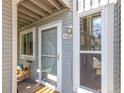 Charming condo entrance with a screen door, unit number, and a small porch for outdoor storage at 4855 Edison Ave # 112, Boulder, CO 80301