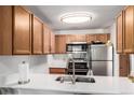 Bright kitchen features stainless steel appliances, a modern faucet, and a lovely white countertop at 4855 Edison Ave # 112, Boulder, CO 80301