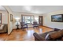 Comfortable living room featuring hardwood floors, natural light, and a cozy seating area at 12154 W Exposition Dr, Lakewood, CO 80228
