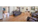 Spacious living room with hardwood floors, classic furnishings, and an open layout perfect for entertaining at 12154 W Exposition Dr, Lakewood, CO 80228