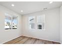 Inviting bedroom featuring a large window and light wood-look flooring at 1080 Joseph Pl, Erie, CO 80026