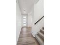 Bright entryway featuring hardwood floors and a stairway with carpeted steps at 1080 Joseph Pl, Erie, CO 80026