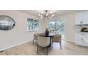 Dining area features round table with neutral chairs and sliding door to the deck at 6876 Quay Ct, Arvada, CO 80003