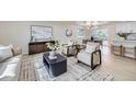 Bright living room features modern decor, neutral colors, and lots of natural light at 6876 Quay Ct, Arvada, CO 80003