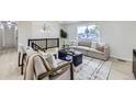 Upstairs living room features modern decor, neutral colors, and lots of natural light at 6876 Quay Ct, Arvada, CO 80003