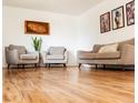 Comfortable living area featuring hardwood floors and neutral colored furnishings at 357 Saturn Pl, Lone Tree, CO 80124