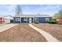 Charming blue home exterior with a walkway to the front door and potential for landscaping at 932 Quentin St, Aurora, CO 80011
