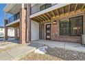 Townhome entrance with brick facade and covered walkway at 9637 Browns Peak Cir, Littleton, CO 80125