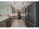 Modern kitchen featuring stainless steel appliances, granite countertops, and ample cabinet space at 6689 Kendrick Dr, Arvada, CO 80007