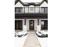 Front view of a charming two-story home with a dark brown front door and balcony at 965 S Downing St, Denver, CO 80209