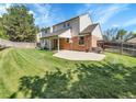 Expansive backyard featuring a covered patio and lush green lawn is perfect for outdoor entertaining at 7405 S Jackson Ct, Centennial, CO 80122
