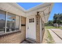 Inviting front door with windows and a well-manicured brick facade at 1148 Rosemary St, Denver, CO 80220