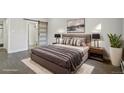 Stylishly staged main bedroom features a sliding door and plush bedding for a cozy space at 3184 S Heather Gardens Way # 406, Aurora, CO 80014