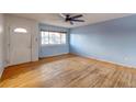 Living room with hardwood floors, light blue walls, and a ceiling fan at 13643 E Exposition Ave, Aurora, CO 80012