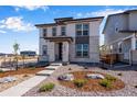 Two-story home with light-colored siding and stone accents at 24801 E 33Rd Dr, Aurora, CO 80019