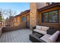 Relaxing outdoor deck with comfortable wicker seating and views of the surrounding neighborhood at 9400 E Iliff Ave # 37, Denver, CO 80231