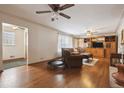 Spacious living room boasting hardwood floors, ceiling fans, a large window and a wooden entertainment center at 615 Estes St, Lakewood, CO 80215