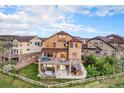 Expansive backyard with multi-level deck, patio seating and meticulously manicured lawn at 10705 Pinewalk Way, Highlands Ranch, CO 80130