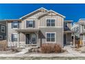 Charming two-story home featuring a covered porch, modern siding, and complementary blue shutters against a clear sky at 17548 Bluetrail Ave, Parker, CO 80134