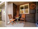 Inviting front porch with wooden chairs and planters at 5123 Bryant St, Denver, CO 80221