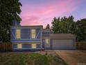 Charming home with a garage and landscaped front yard set against a beautiful twilight sky, offering suburban living at 1956 Cathay St, Aurora, CO 80011