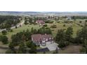 Scenic view of a two story home surrounded by trees and a vast landscape at 7641 Kelty Trl, Franktown, CO 80116