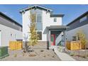 Charming two-story home with a bright red front door and professionally landscaped front yard at 21021 E 63Rd Dr, Aurora, CO 80019