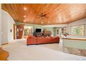 Open-concept living area with hardwood floors, a fireplace, and ample natural light at 30174 Glen Eyrie Dr, Evergreen, CO 80439