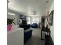 Living room with blue sofas, gray walls, and a large flat screen TV at 4824 S Eaton Park Way, Aurora, CO 80016