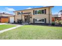 Charming two-story home featuring a brick and siding exterior, manicured lawn, and inviting entryway at 3065 Zion St, Aurora, CO 80011