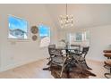 Cozy dining area features a round table, modern chandelier, and large windows at 1101 S Dahlia St, Denver, CO 80246