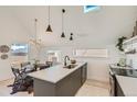 Modern kitchen with island, stainless steel appliances, and an adjacent dining area at 1101 S Dahlia St, Denver, CO 80246