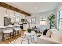 Open-concept living room and kitchen with hardwood floors and ample natural light at 1120 Xenia St, Denver, CO 80220