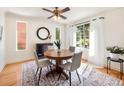 Cozy dining room with natural light, hardwood floors, and a modern chandelier at 1470 Utica St, Denver, CO 80204