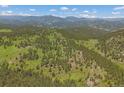 Breathtaking mountain and valley views from this property, surrounded by dense forests at 3800 Lakota Rd, Indian Hills, CO 80454