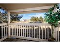 Covered patio showcasing neighborhood view with surrounding trees and lawn, offering an inviting outdoor area at 1960 S Xanadu Way # 208, Aurora, CO 80014