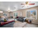Spacious living room features hardwood floors, bright windows, and stylish, comfortable seating at 4570 S Kalispell Way, Aurora, CO 80015